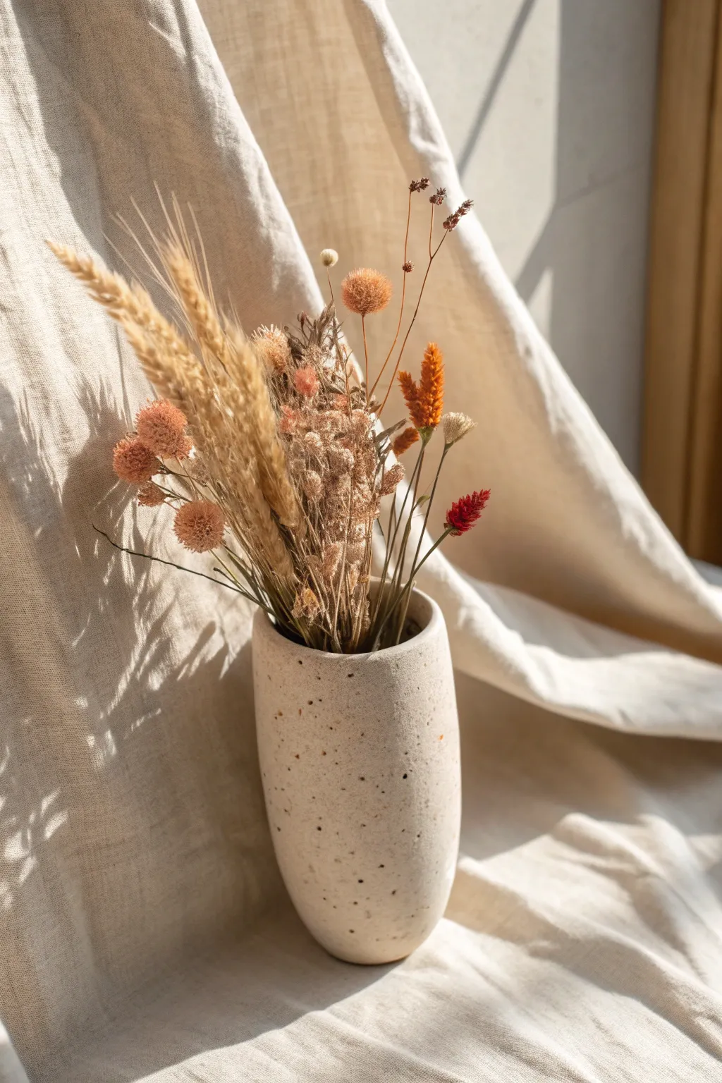 Minimal clay wall pocket vase styled with warm dried florals for a cozy, handmade cottage vibe