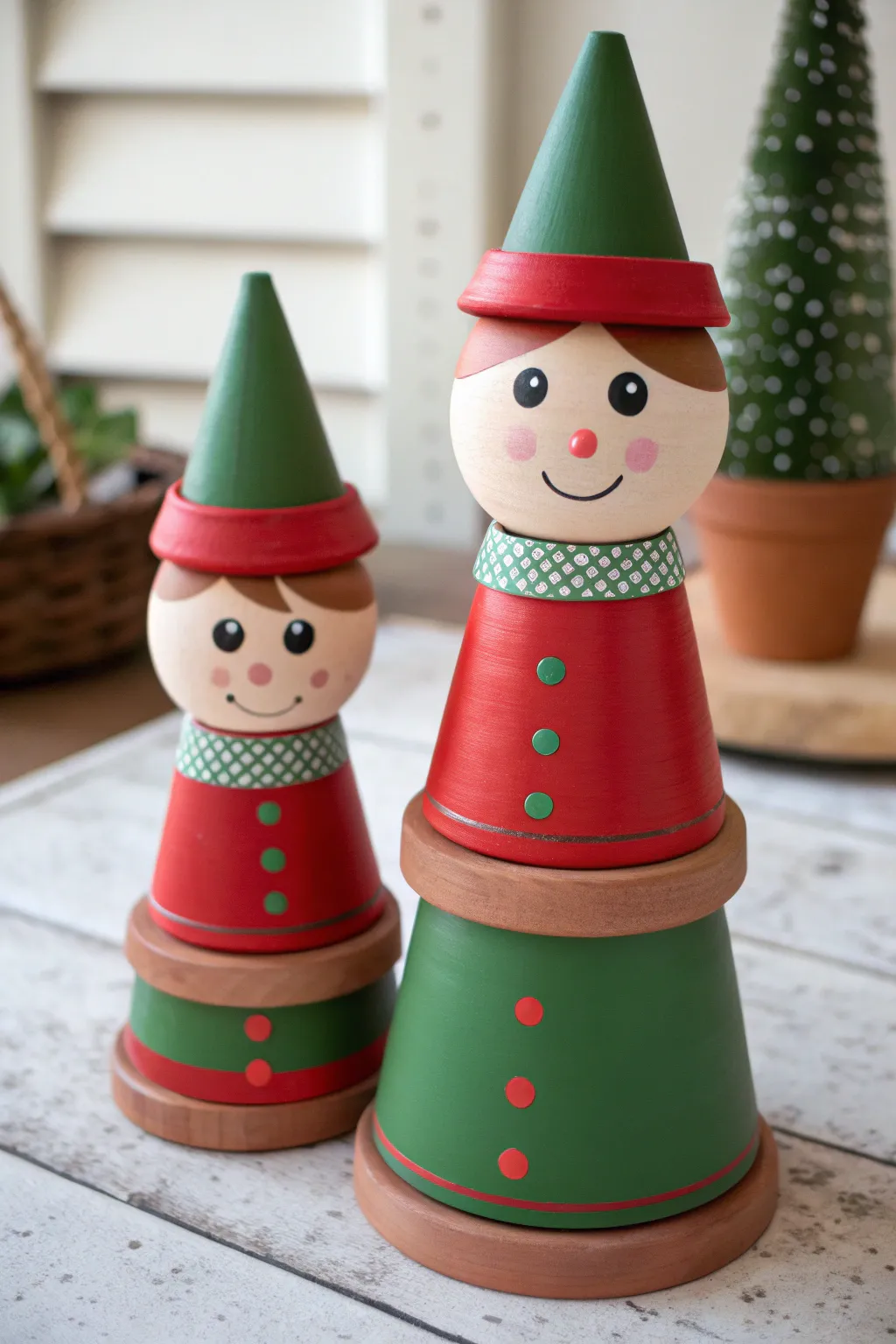 Sweet stacked terracotta elf buddies in cozy red and green, a minimalist boho Christmas duo