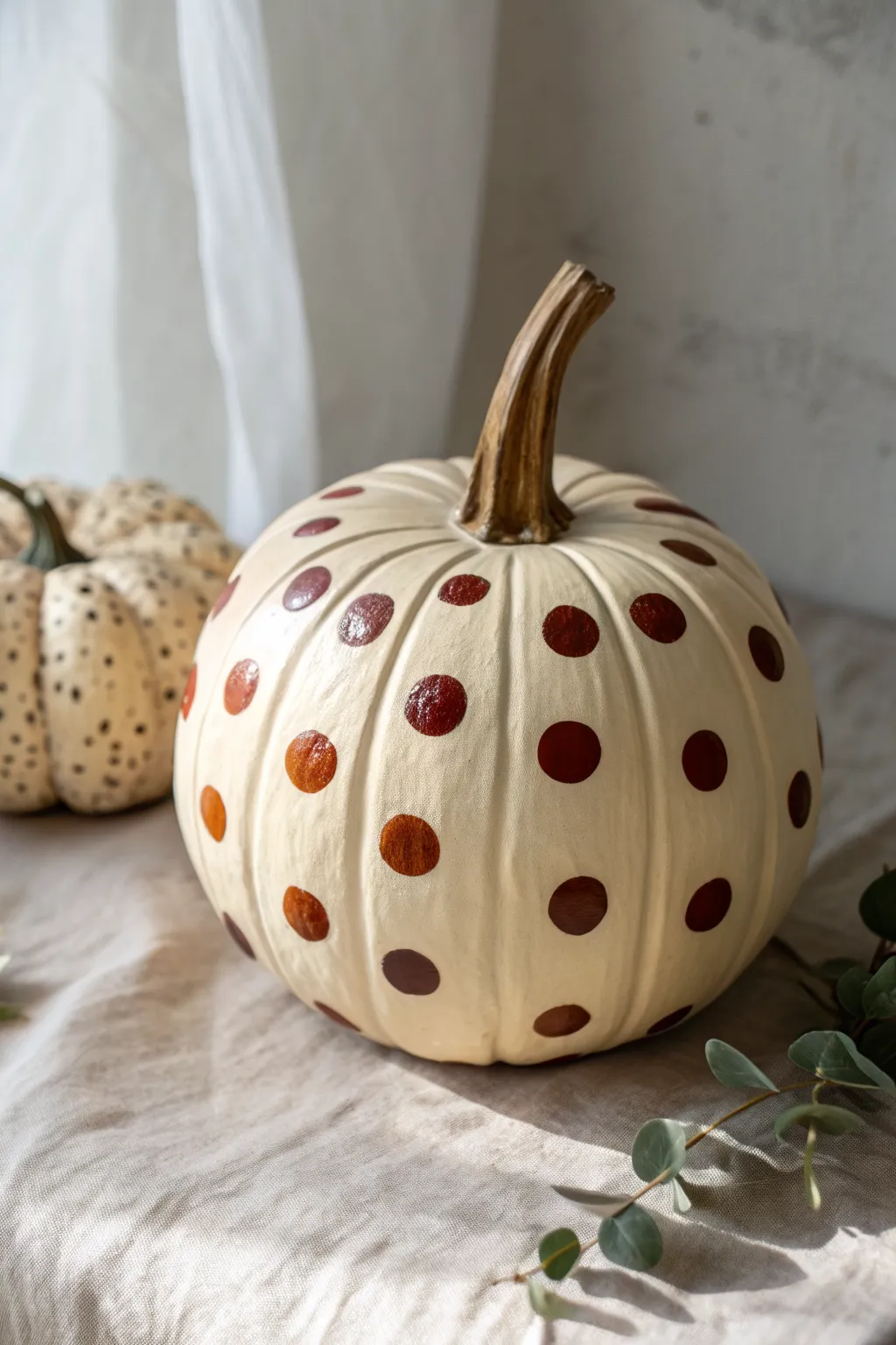Fall-neutral polka dot clay pumpkin: simple, bold dots for an easy cozy Scandinavian look.