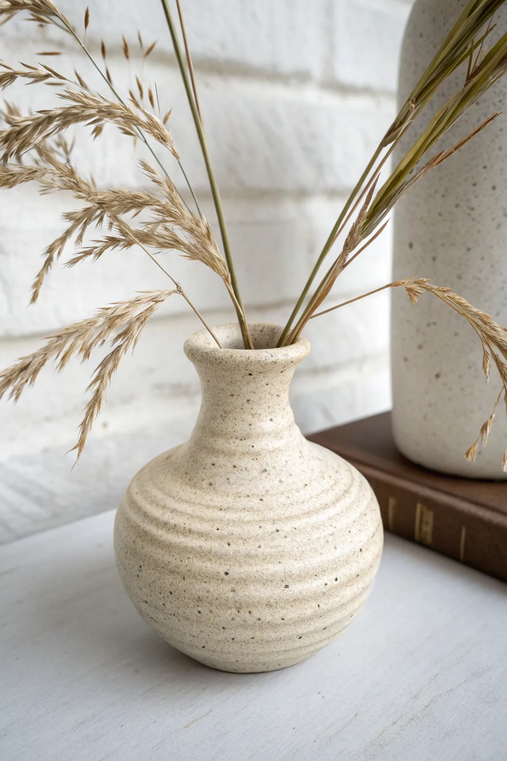 Beginner coil-built bud vase with clean rings and a simple stem for soft, minimalist styling