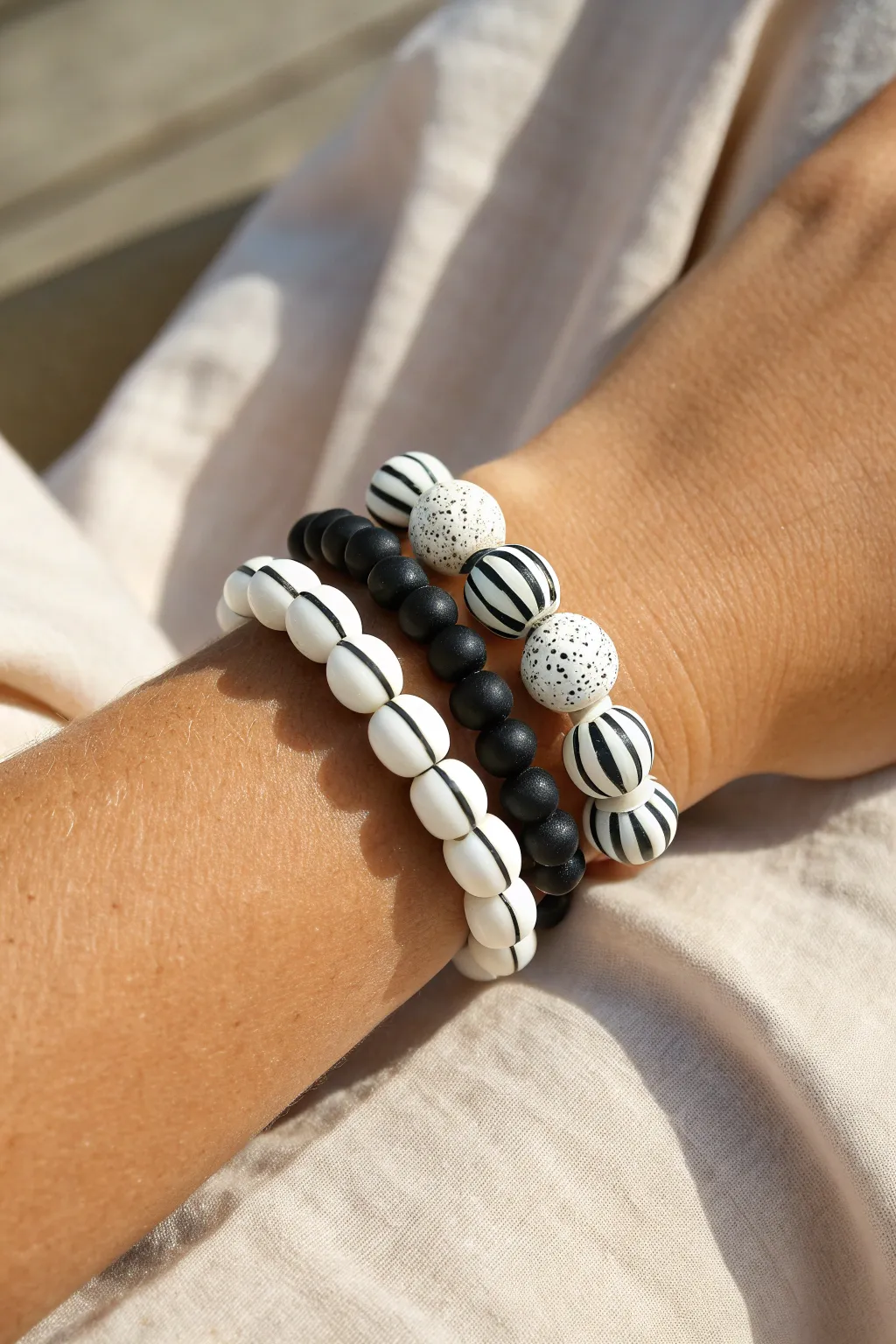 Crisp black-and-white clay bead stacks with bold stripes for a cool, minimalist bracelet look