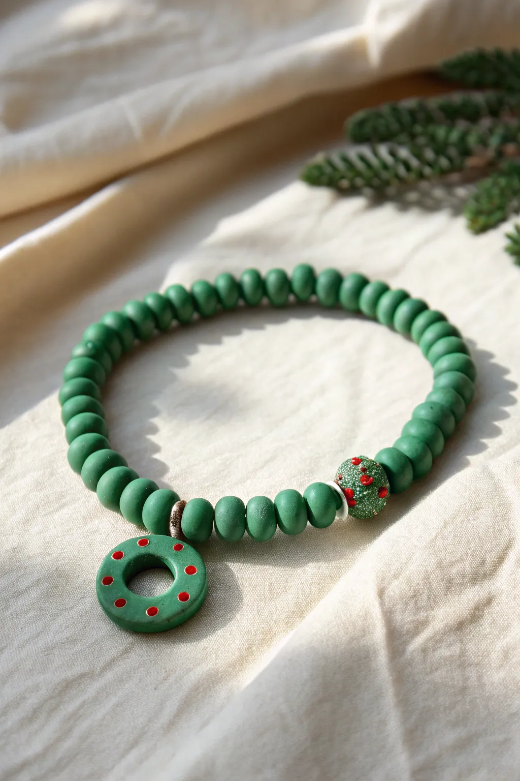 Wreath-inspired green clay bead bracelet with a red-accent center, simple Scandinavian Christmas charm