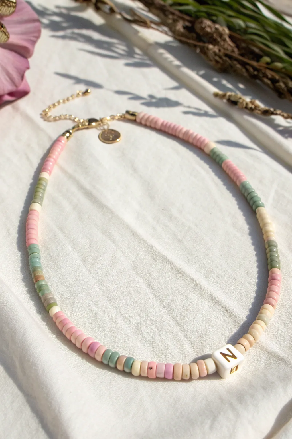 Pastel heishi choker with a single initial bead for an easy personalized pop in your stack