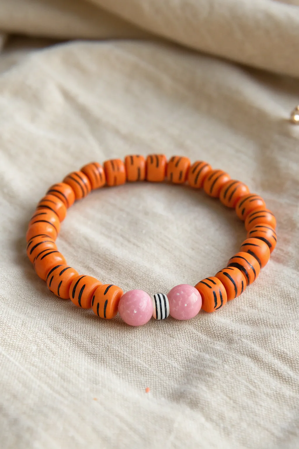 Tiger stripe clay bead bracelet kit vibes in warm orange and black, a cute pink nose accent