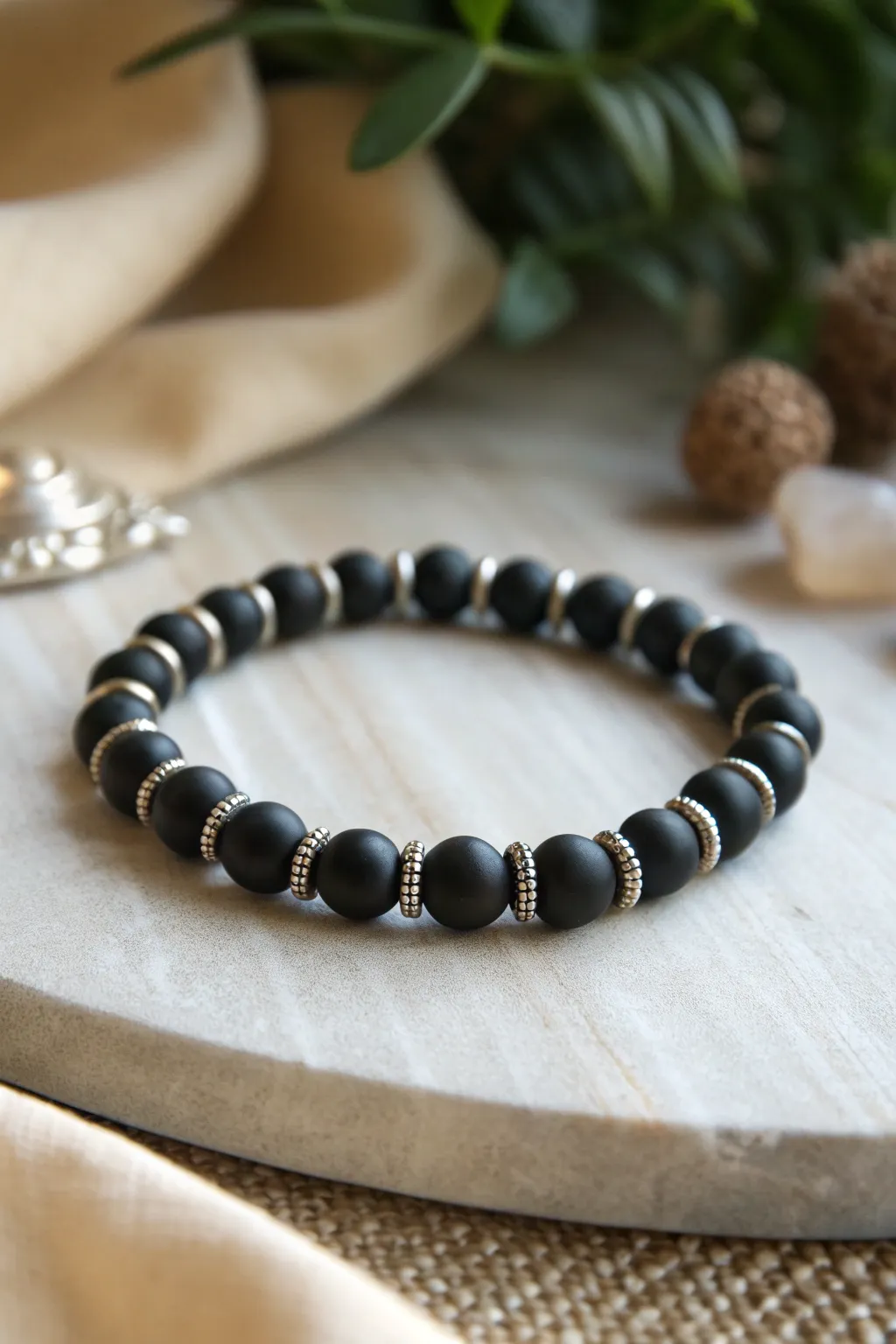 Sleek all-black clay bead bracelet with silver spacers for a minimal, modern girls look