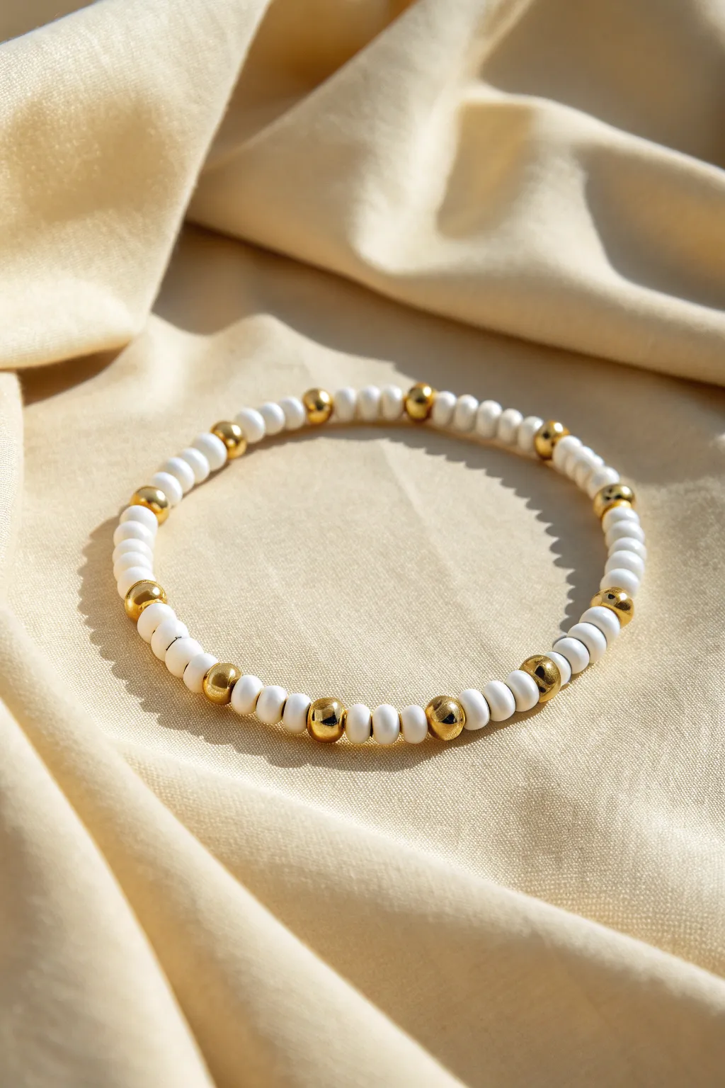 White clay heishi beads with gold spacers for a clean, modern bracelet that feels effortlessly luxe.