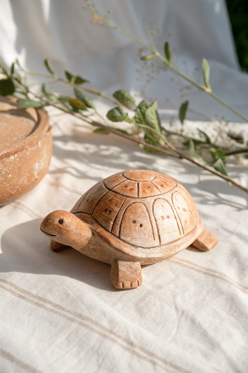 Pocket-size clay turtle with a simple patterned shell in warm, earthy Scandinavian tones.