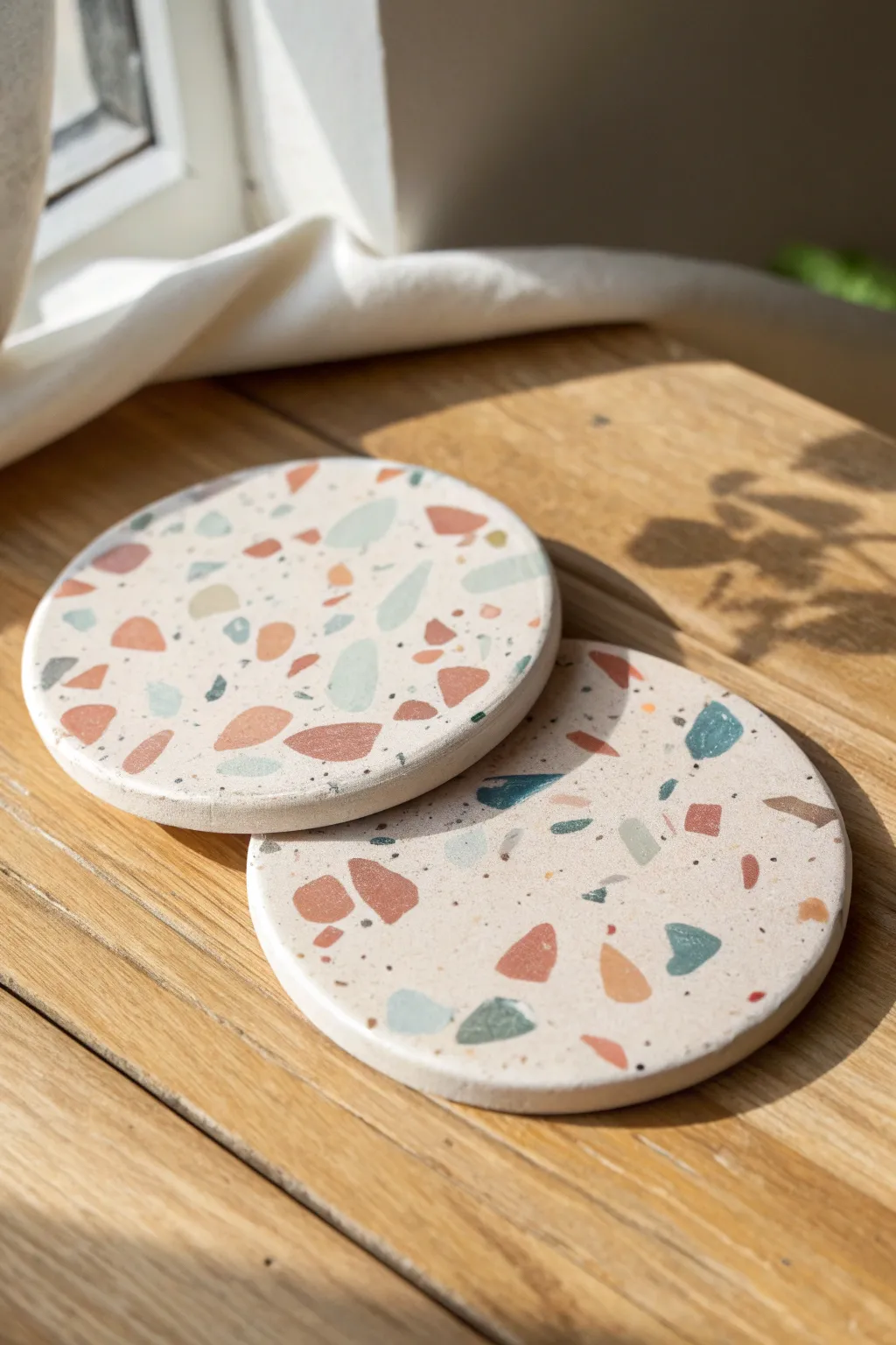 Terrazzo polymer clay coasters in soft neutrals and pastels, stacked for a clean minimalist look