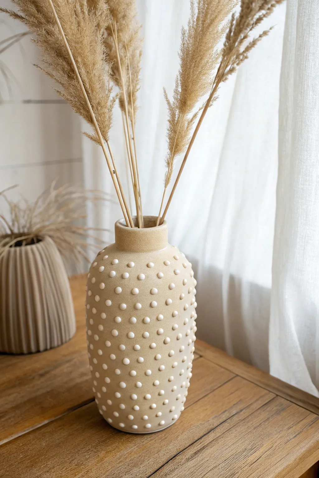 Minimalist polymer clay vase with raised polka dots and pampas for soft boho contrast.