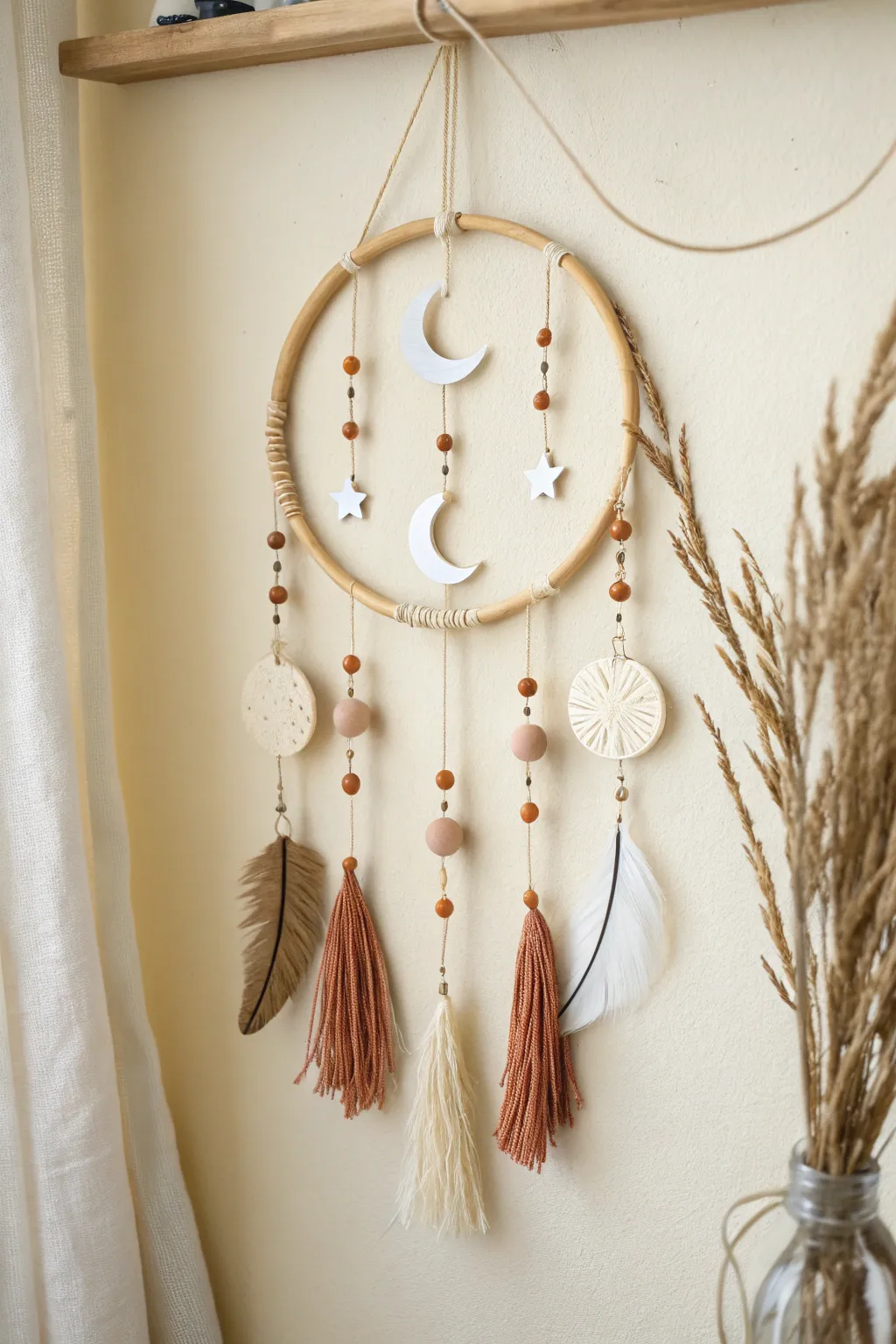 Dreamcatcher-style hoop wall hanging with simple polymer clay charms in soft boho neutrals