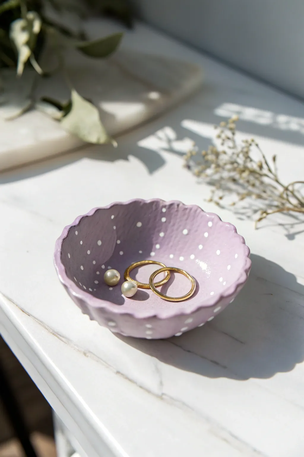 Milky lavender scalloped trinket bowl with dainty dots, perfect for jewelry on a bright vanity