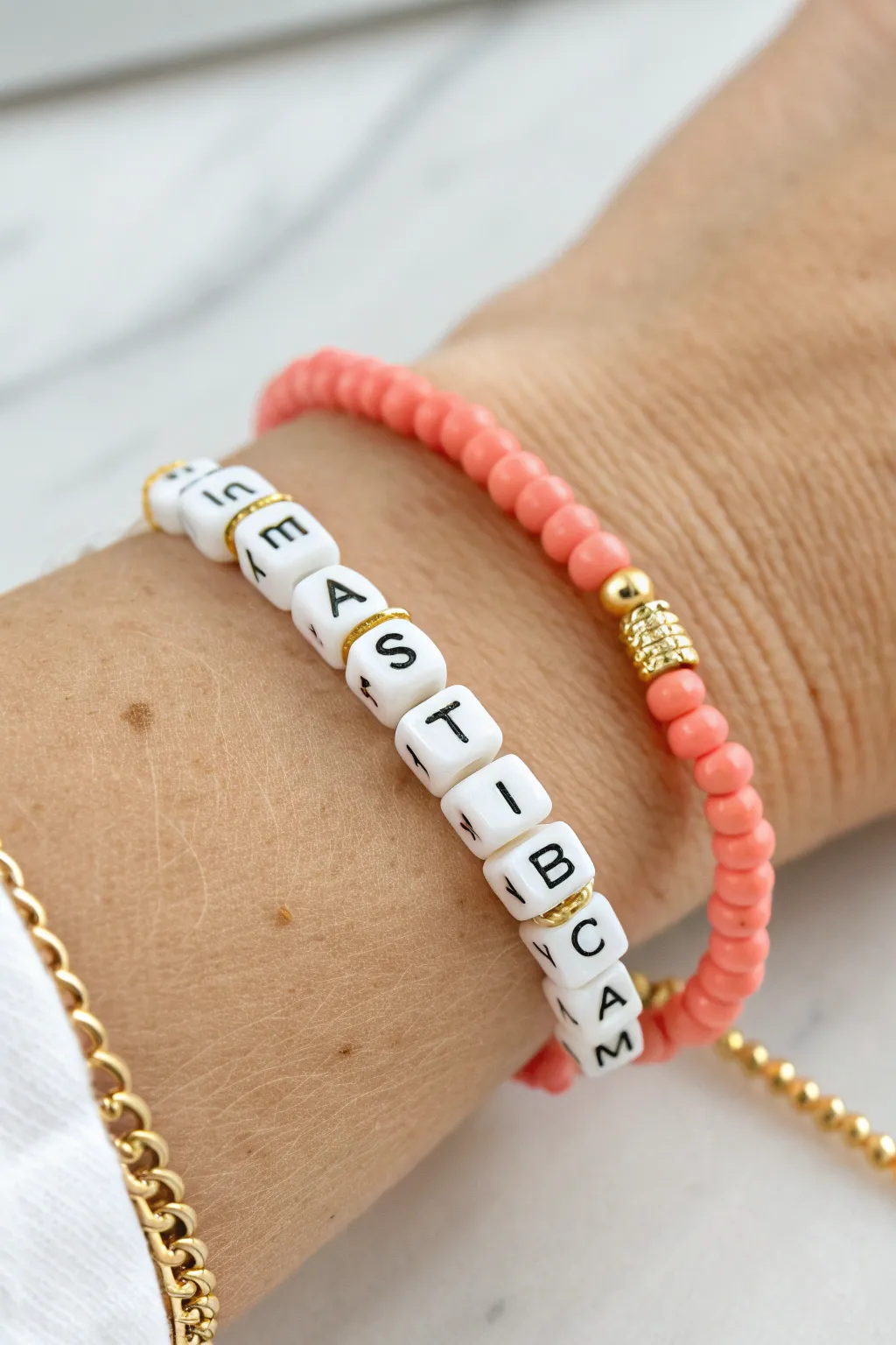 Preppy letter-bead clay bracelet with bright discs and tiny spacers, styled in soft Scandi boho.