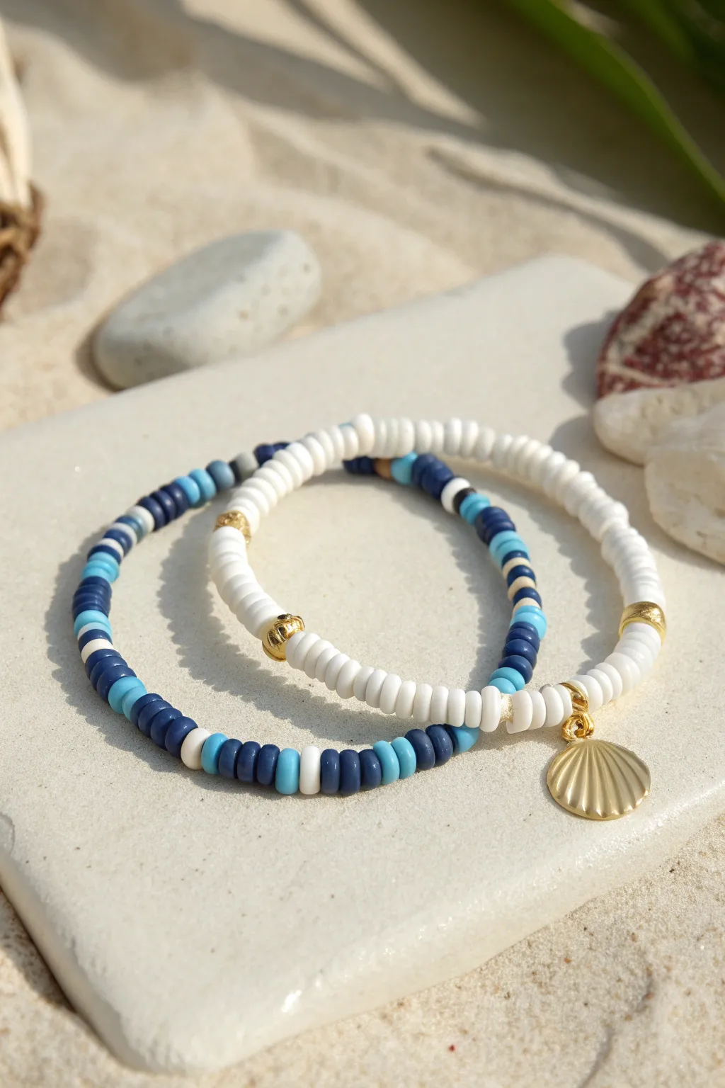 Coastal prep perfection with navy and white clay bead stripes and a simple charm accent.