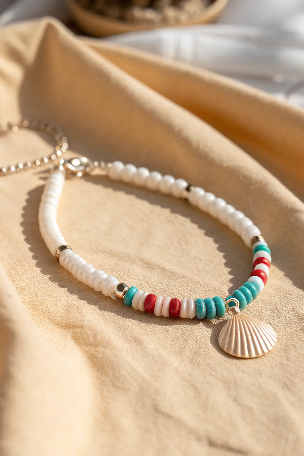Shell charm beach-prep bracelet in white, turquoise, and coral for effortless summer style.