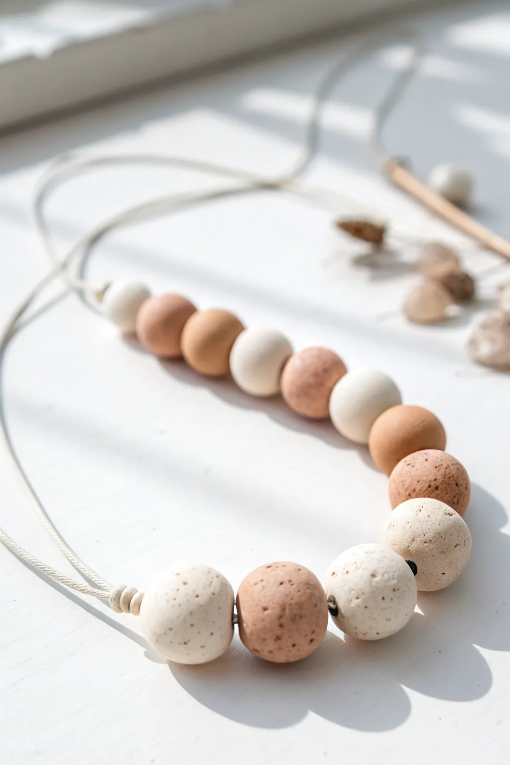 Soft neutral air-dry clay bead strand in minimalist Scandinavian styling with gentle contrast