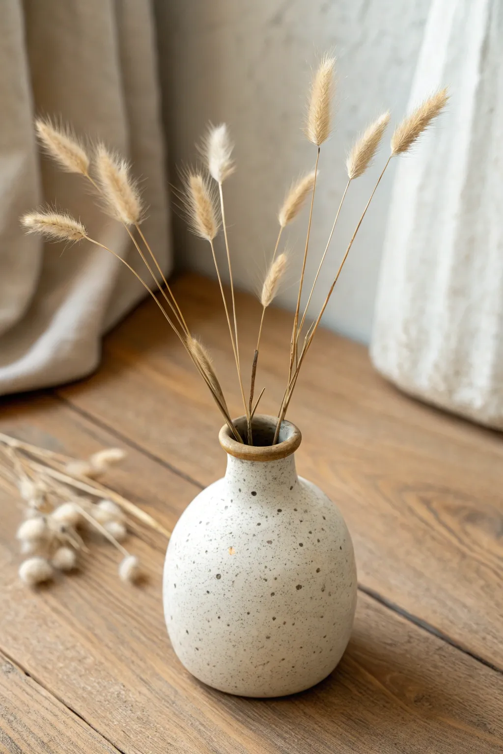 Tiny wabi-sabi bud vase with dried stems, minimalist and easy to recreate at home