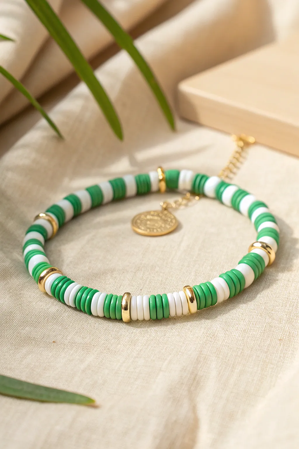 Green and white striped clay heishi bracelet with tiny gold accents, simple and festive