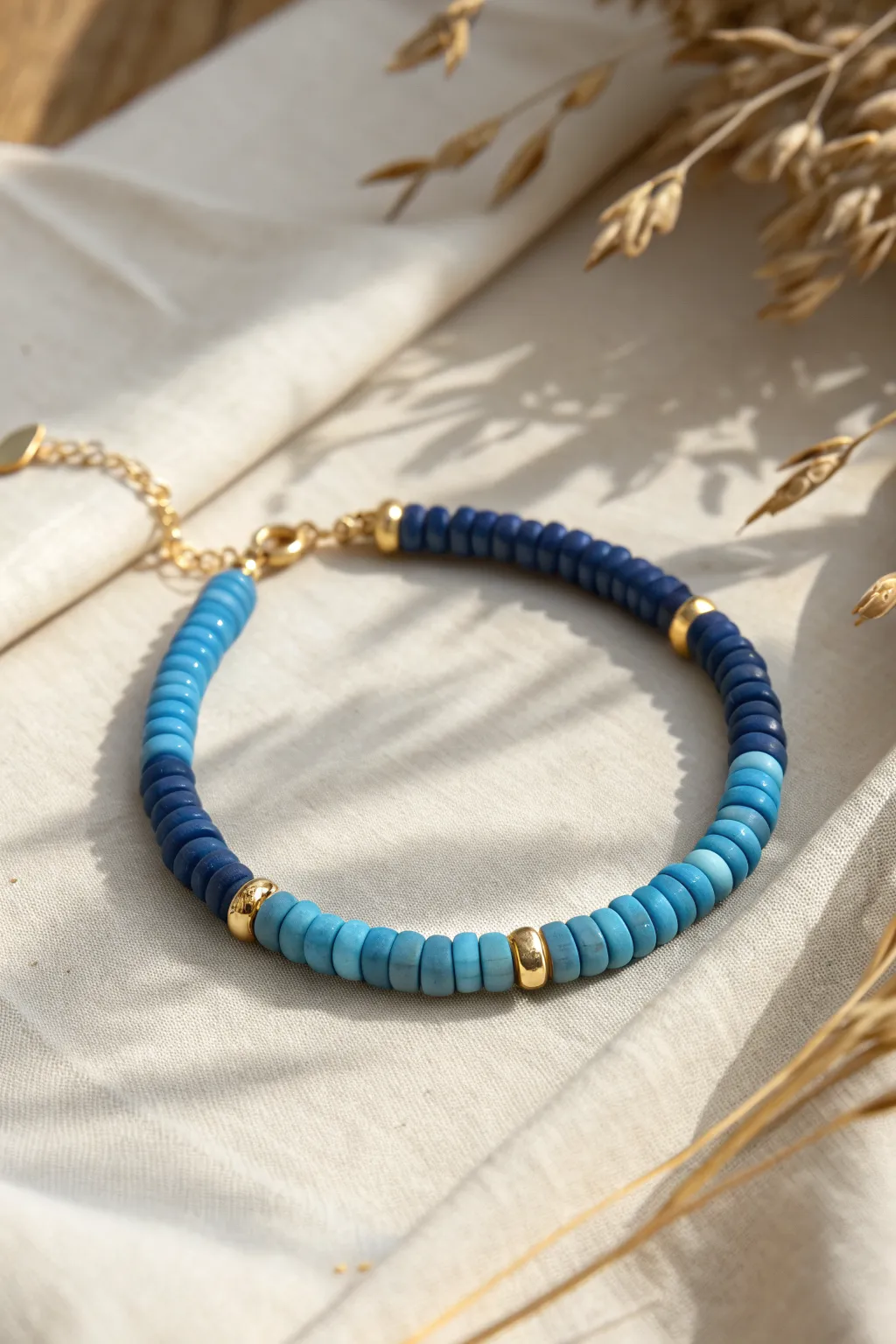Blue heishi beads with tiny gold spacers make this stitch bracelet look polished and effortlessly simple.