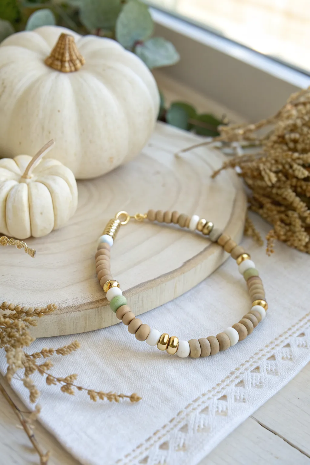 Neutral clay bead bracelet in ivory, tan, and sage for a calm, minimalist Thanksgiving look