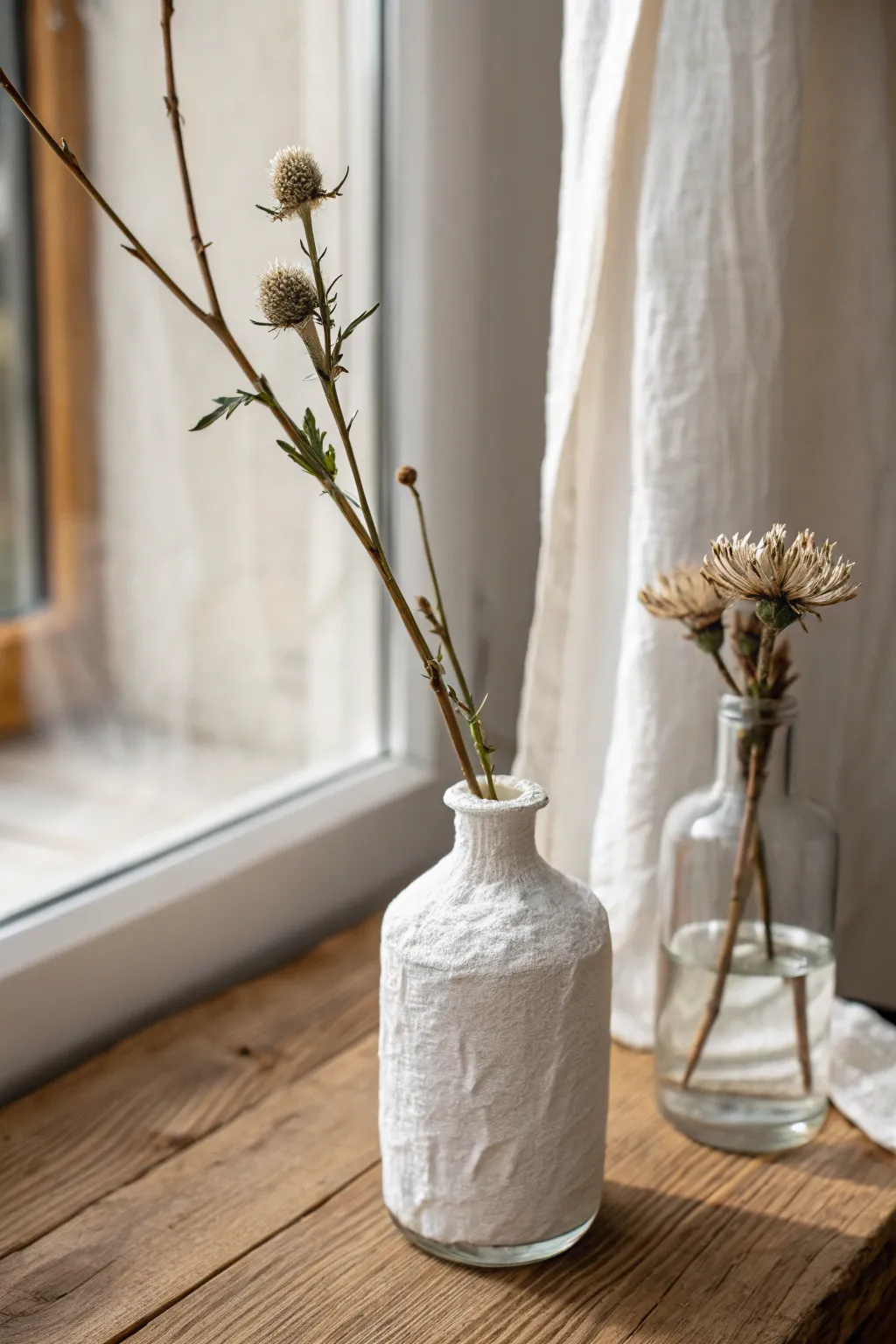 Tiny bud vase wrapped in white air dry clay, softly lit for clean Scandinavian boho style.