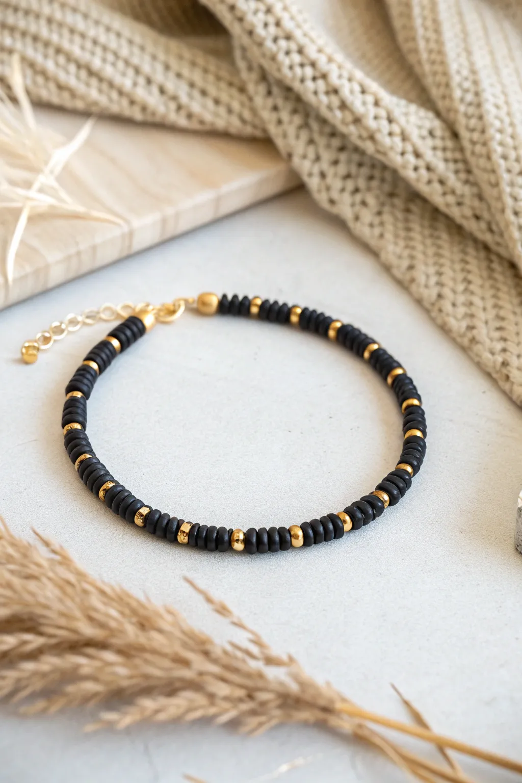 Minimalist black heishi bracelet with gold spacers for a chic, modern everyday look