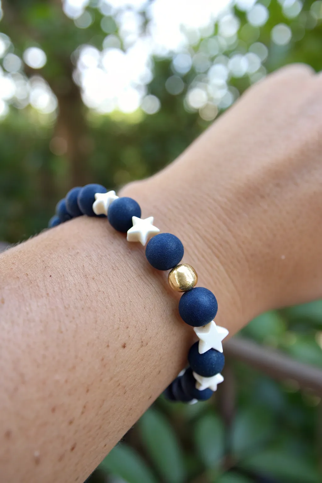 Navy clay beads with crisp white stars and tiny gold spacers for an effortless July look