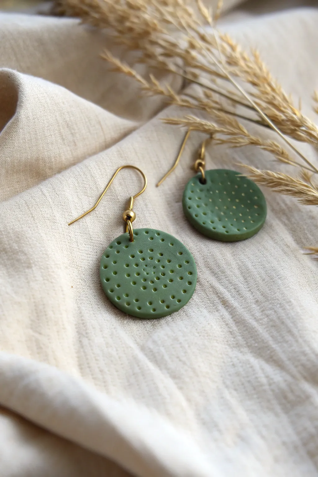 Raised dot texture disc earrings in calming forest green, simple boho minimal style.