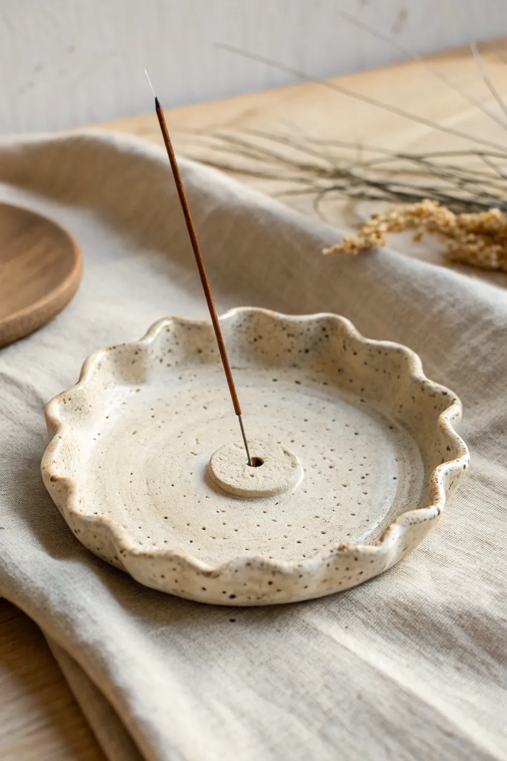 Wavy-edge air dry clay incense plate with raised rim, minimal and feminine, keeps ash contained