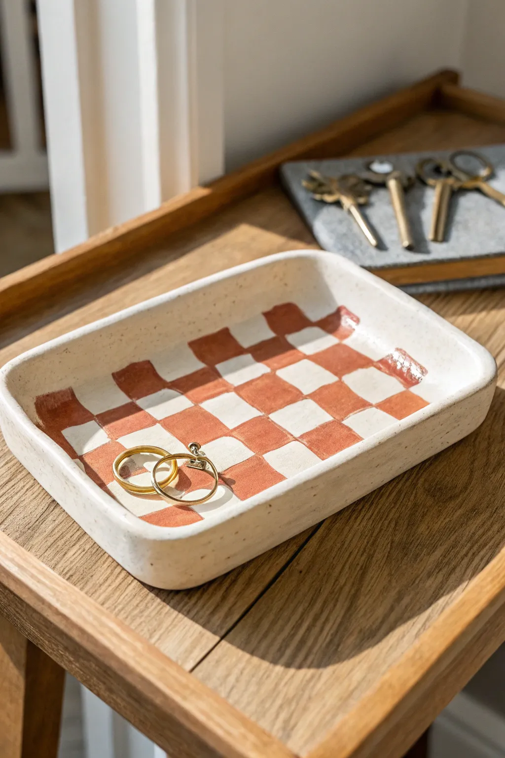 Crisp checkerboard catchall tray in soft neutrals, perfect for keys and rings on your nightstand