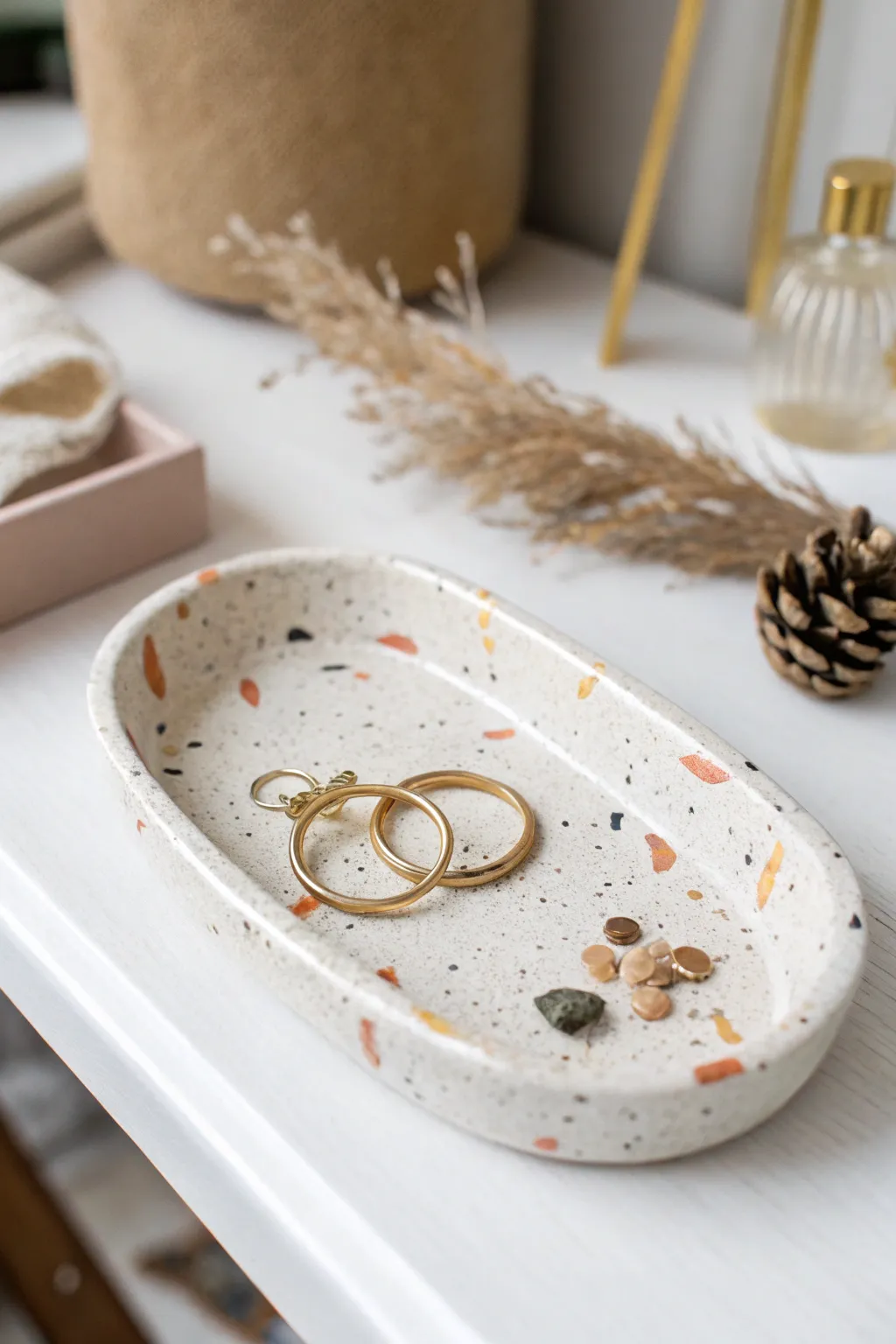 Minimal terrazzo air dry clay trinket tray, styled with simple earrings and a ring