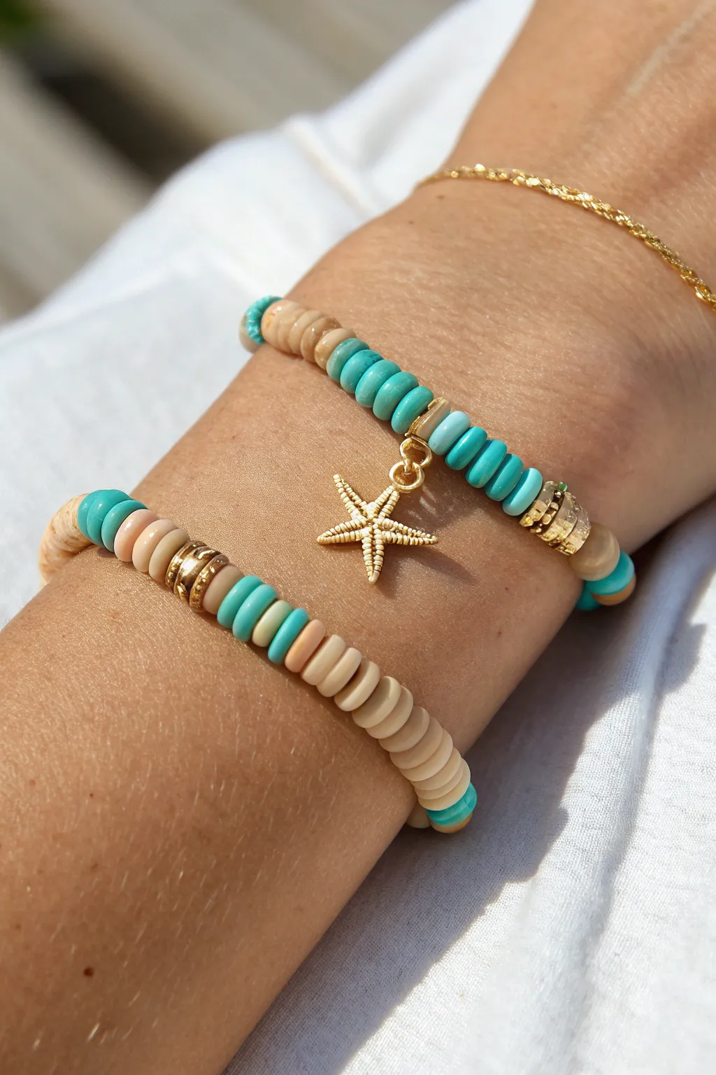 Turquoise and sand heishi bracelet with a dainty starfish charm for effortless beach vibes.