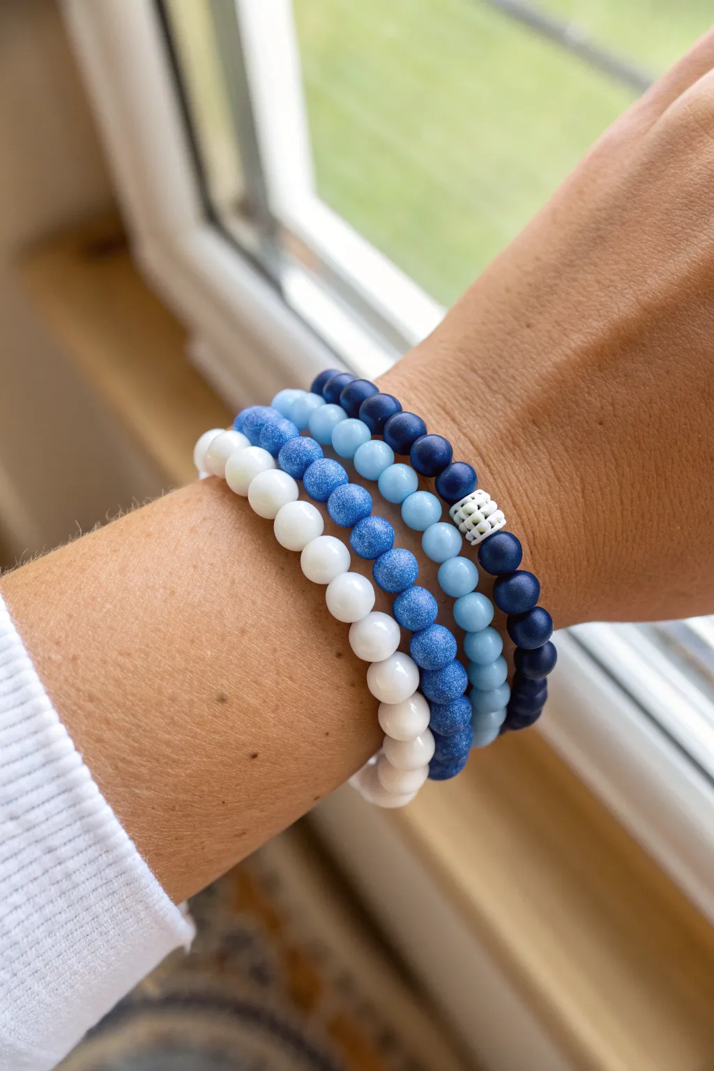 Preppy blue clay bead bracelet stack in baby blue, cobalt, and navy with crisp white accents.