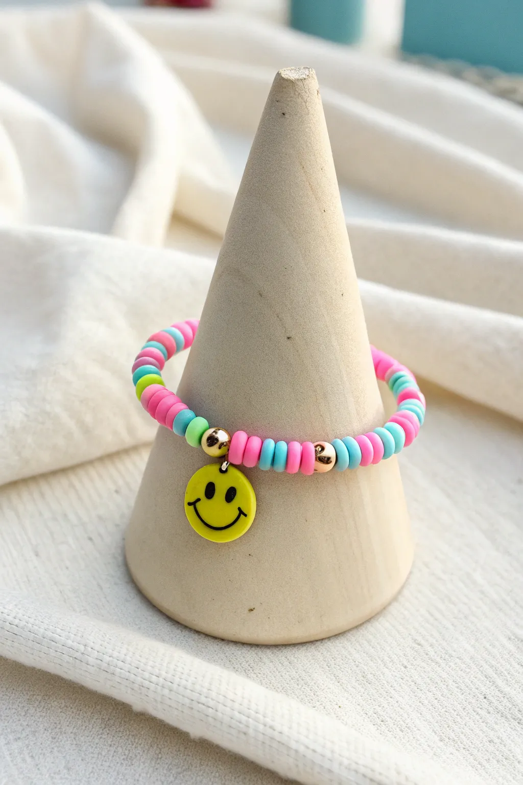 Preppy brights meet a smiley focal bead for a playful clay heishi bracelet with clean style