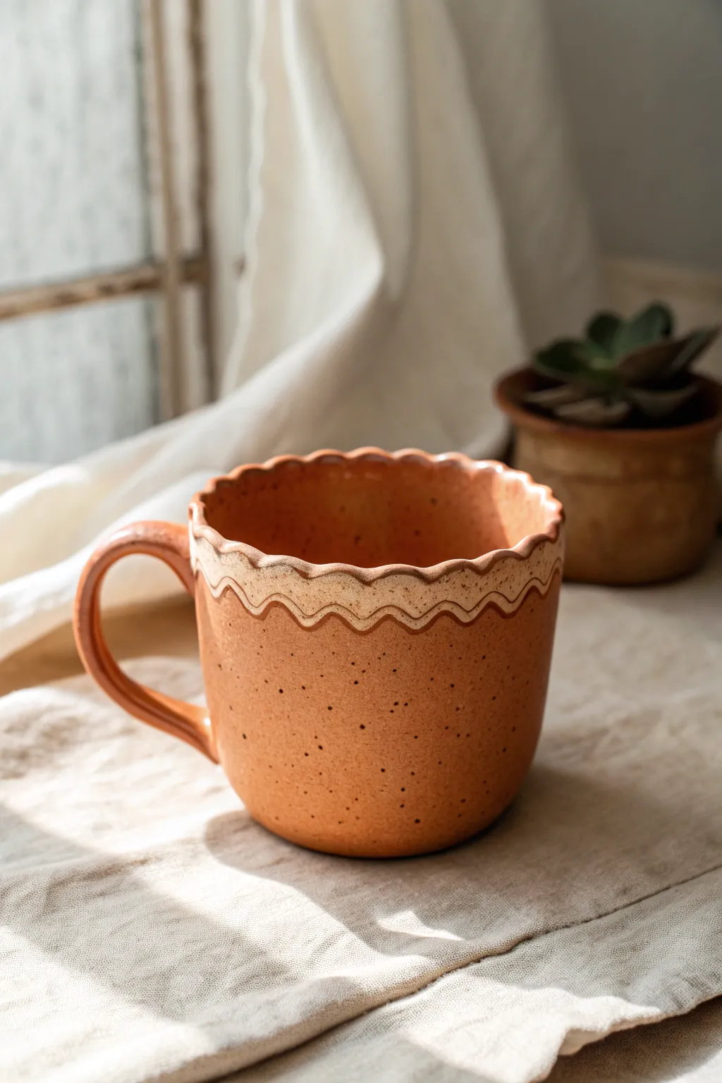 Soft scalloped rim clay cup in warm terracotta, minimal styling, made to be admired