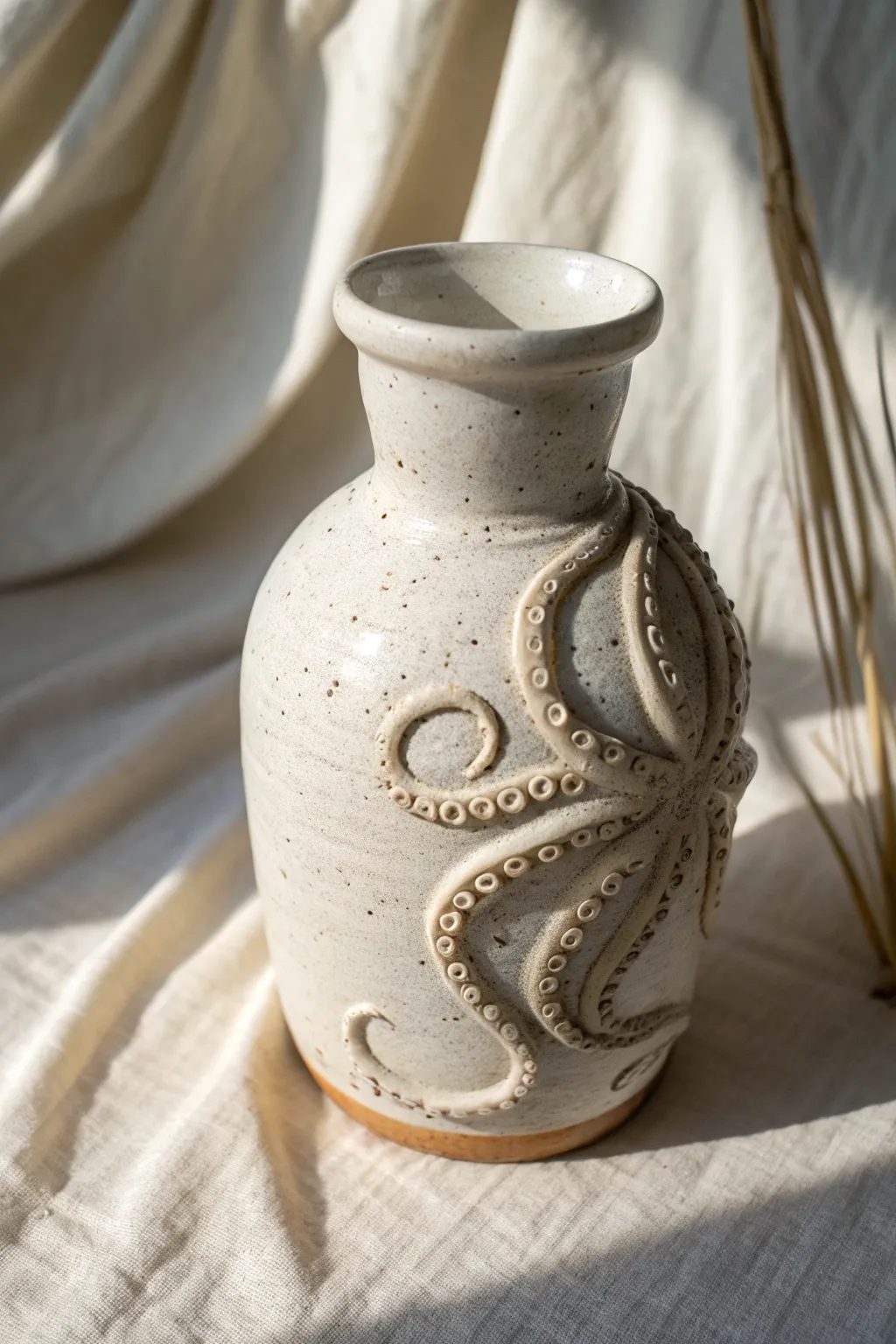Minimalist stoneware vase with an octopus wrap, handmade texture, calm Nordic styling.