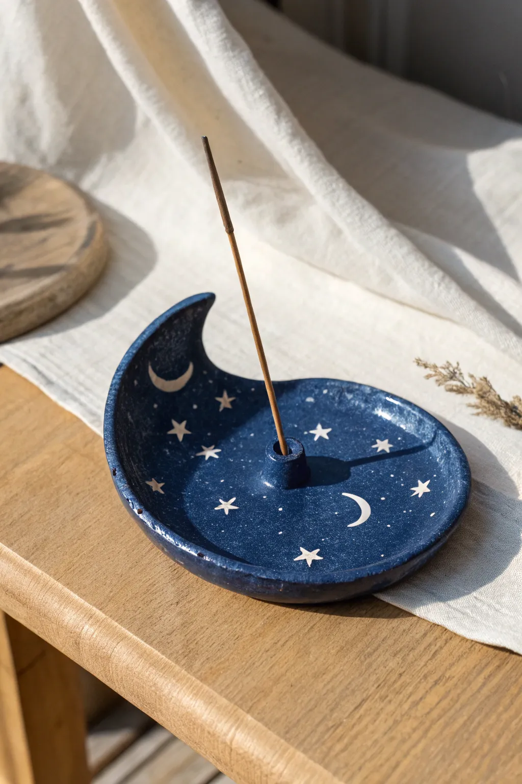 Deep blue crescent moon incense holder with tiny stars, minimal and dreamy for cozy rituals.