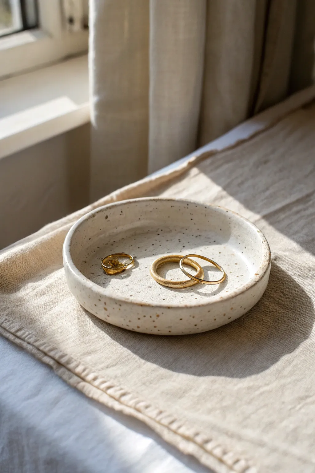 Stamped pattern ring tray with soft texture and stacked rings, minimal Scandinavian boho vibe