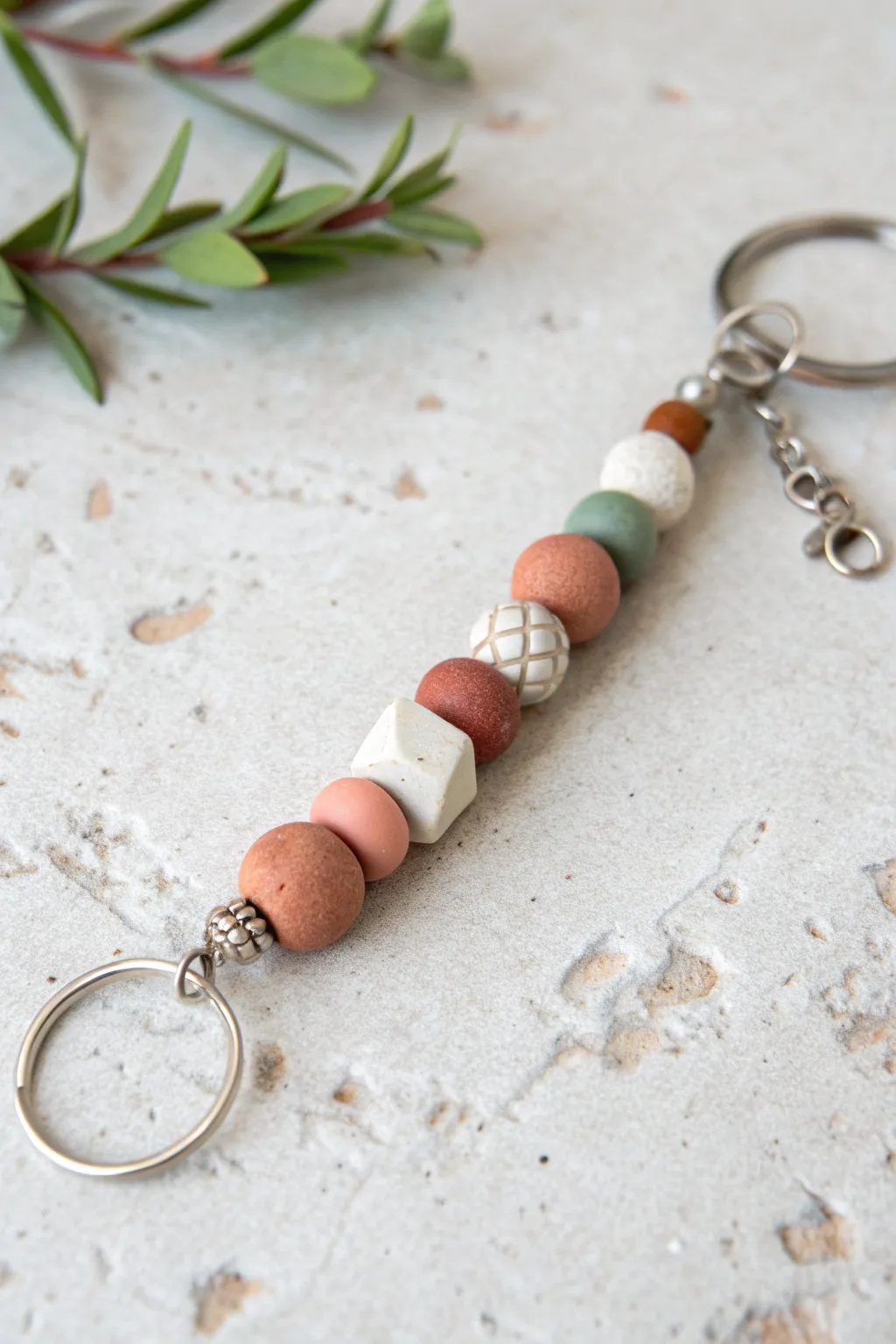 Easy DIY clay bead keychain with chunky round and tube beads in soft boho Scandinavian hues