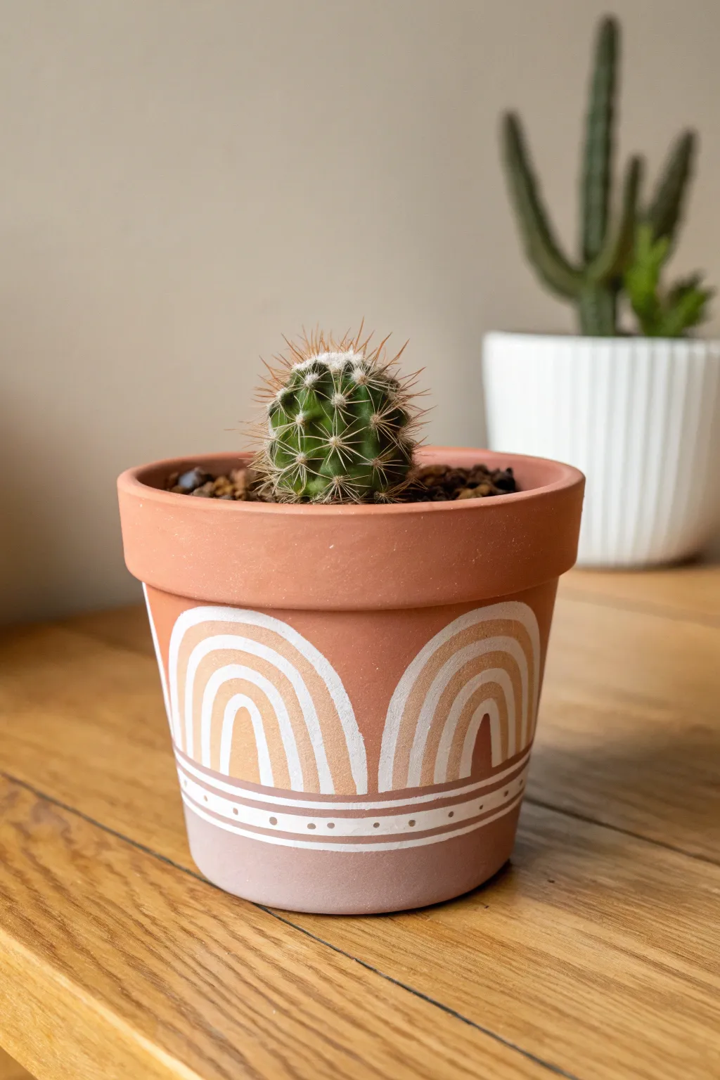 Matte clay pot with boho arches, paired with a tiny cactus for cozy minimalist charm.