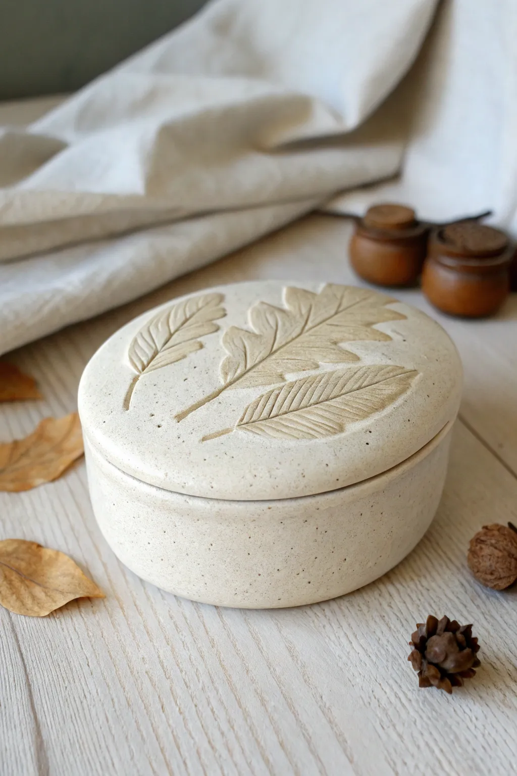 Minimal oval clay trinket box with leaf imprint, a calm botanical touch for your shelf.
