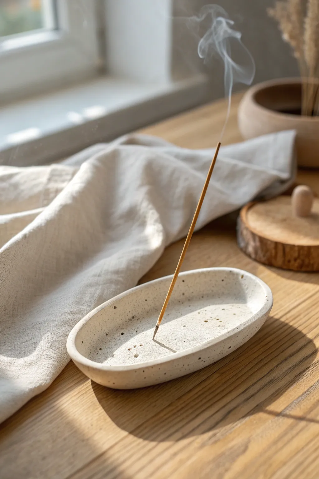 Simple clay incense holder in soft neutrals, clean lines, and calming Scandinavian light