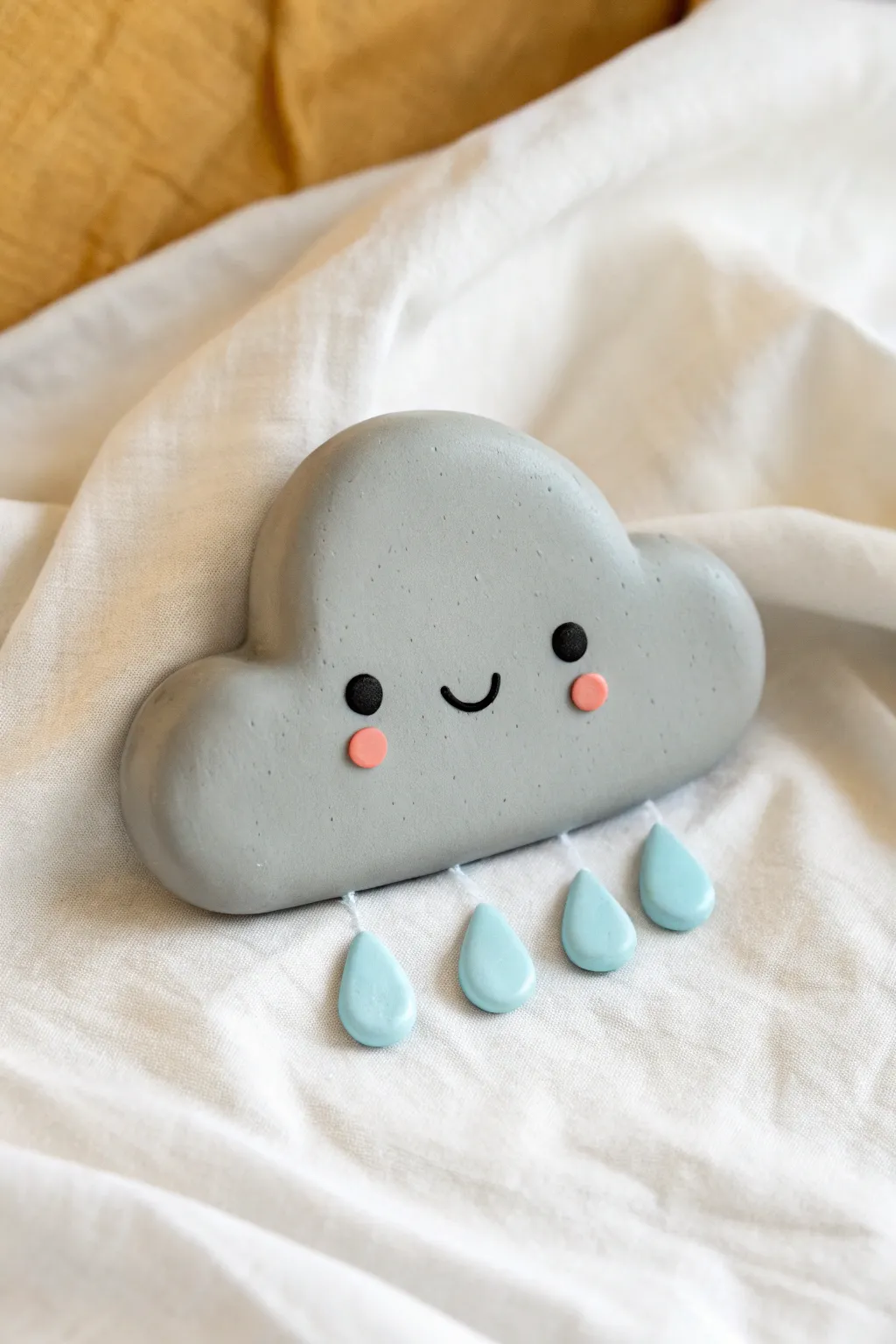 Sweet smiling storm cloud clay charm with simple raindrops, minimalist Scandinavian boho vibe