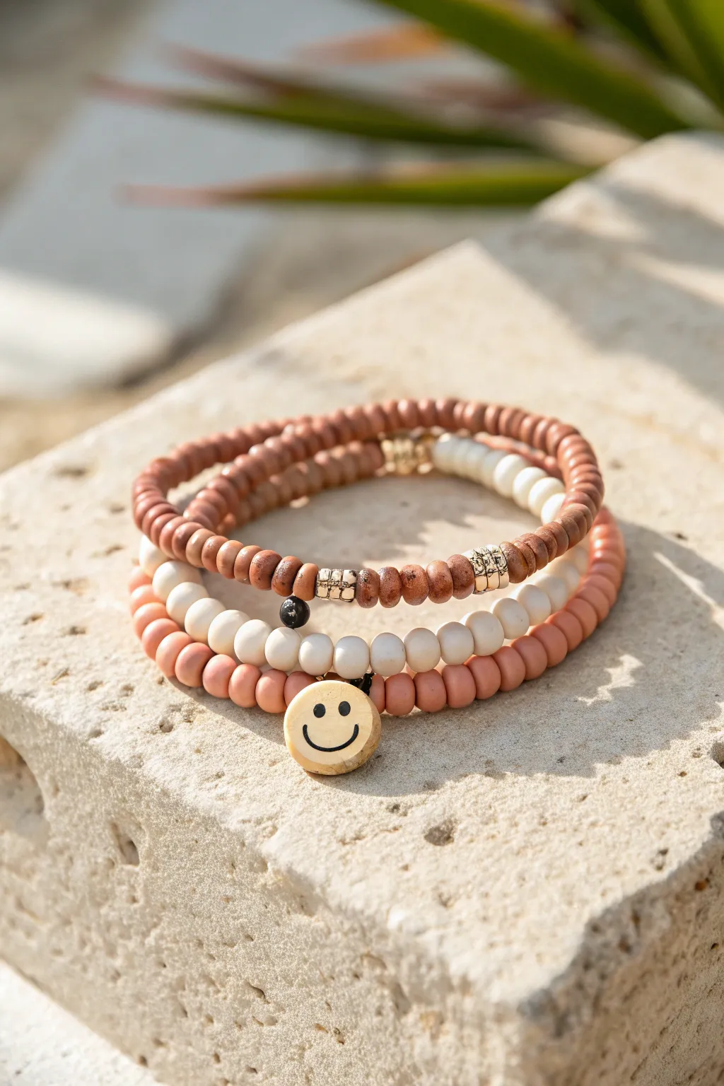 Smiley focal bead bracelet stack paired with matching heishi solids in soft Scandinavian tones