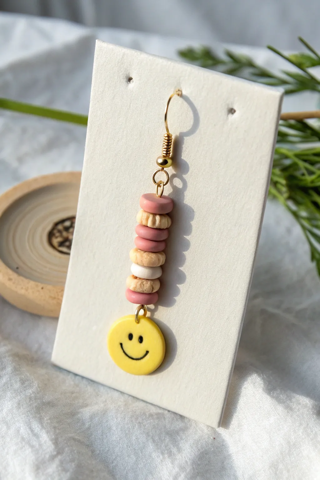 Smiley focal heishi dangles in soft neutrals for a clean Scandinavian look with boho charm