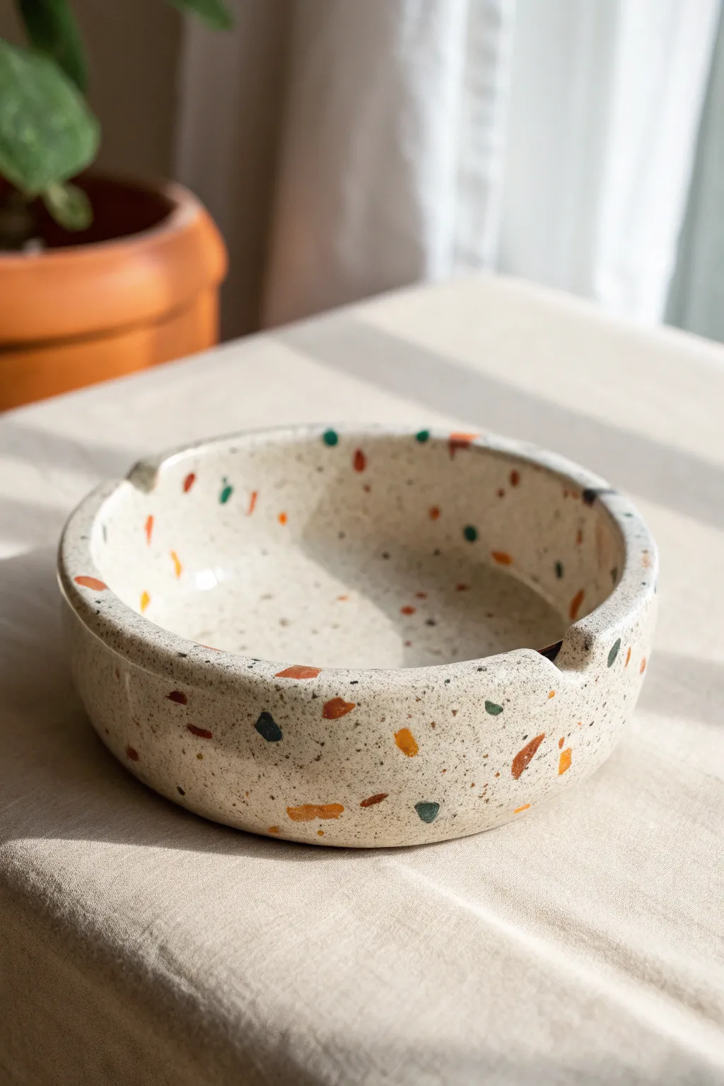 Speckled terrazzo-style clay ashtray with a glossy finish—minimal, cheerful, and handmade.