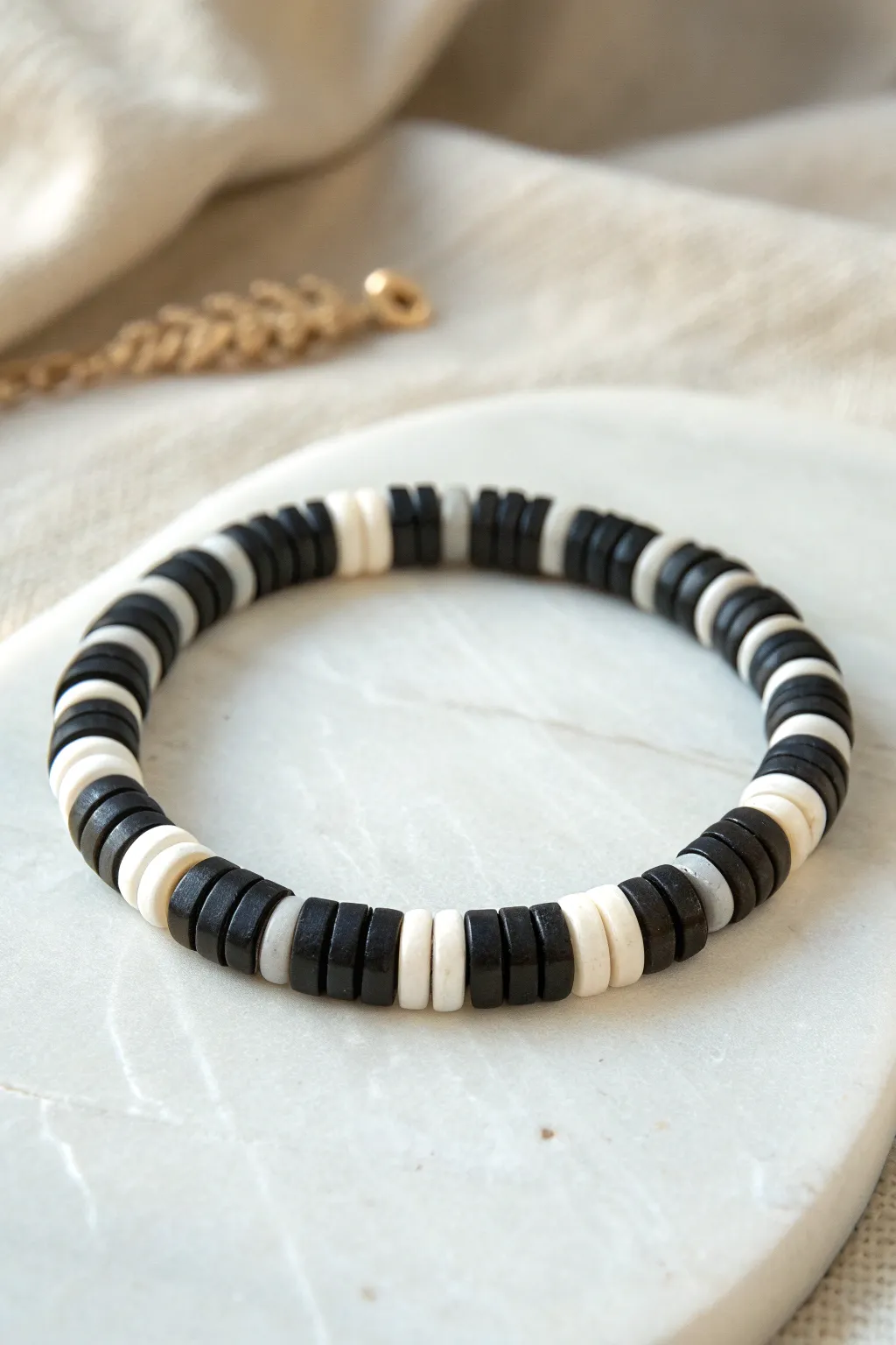 Graphic black-and-white heishi bead bracelet, minimalist style with a soft boho edge.