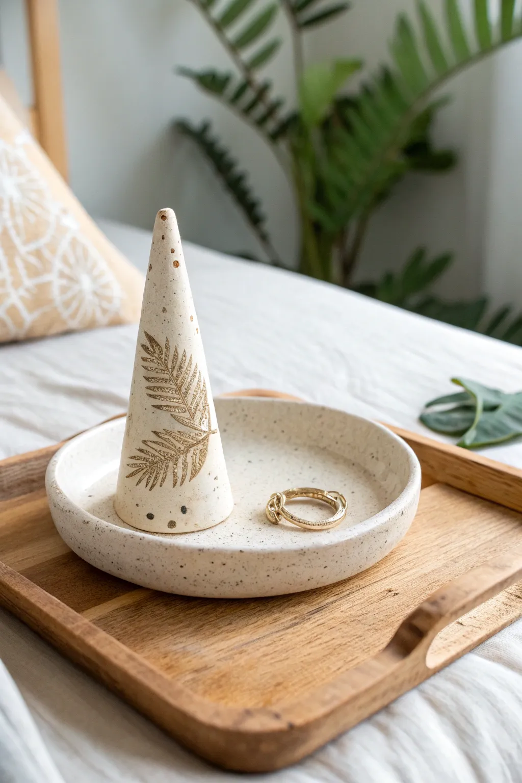 Minimal handbuilt ring cone with stamped jewelry tray, calm Scandinavian boho bedside styling.