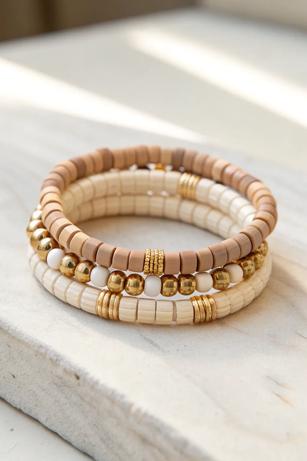 Neutral heishi clay bead stack with gold spacers, a chic grown-up Mothers Day gift idea.