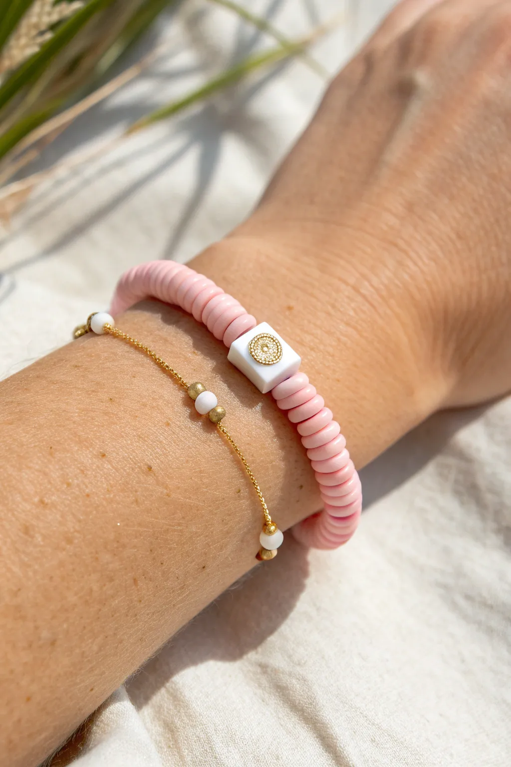 Soft pink heishi bracelet with a centered initial and gold spacers, perfect preppy touch.