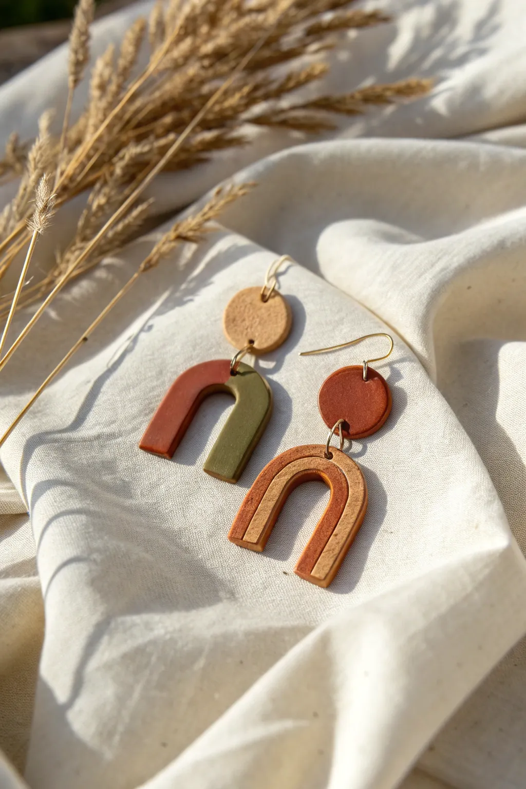 Earthy matte polymer clay earrings in warm neutrals, styled simply on linen for calm boho vibes.